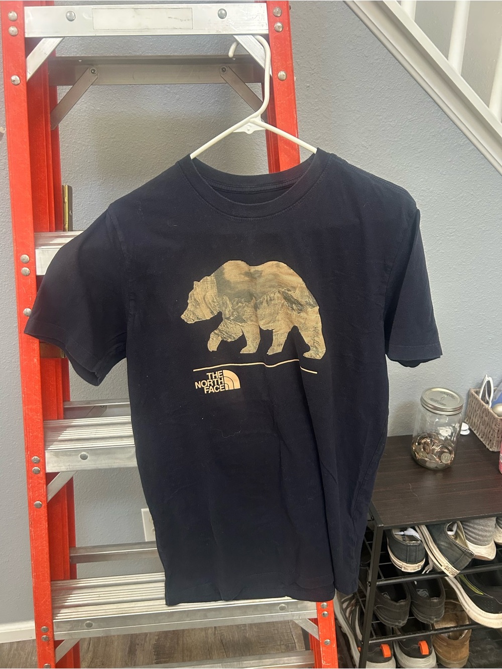 The North Face Black Tee with Gold Bear Graphic